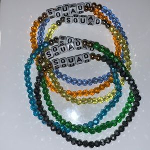 6 stretchy bracelets that read “Squad”.